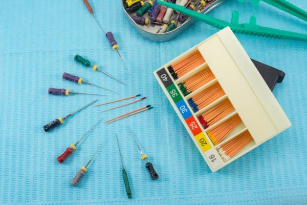 gutta-percha pins in a set of different sizes for root canal filling, endodontic ruler close-up, material for endodontic filling